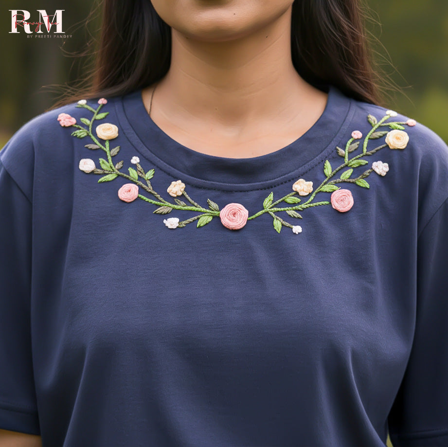 Navy blue shirt with floral embroidery on a blurred natural background