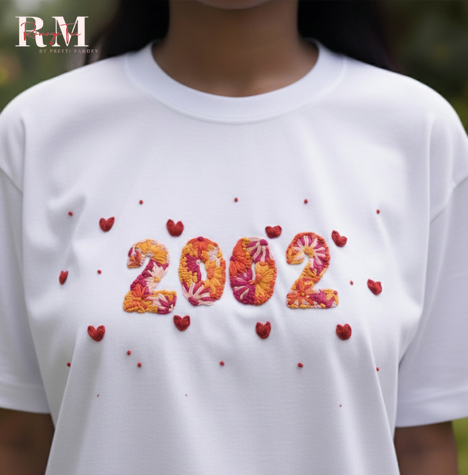 White t-shirt with '2002' design and red hearts, brand 'RM' visible.