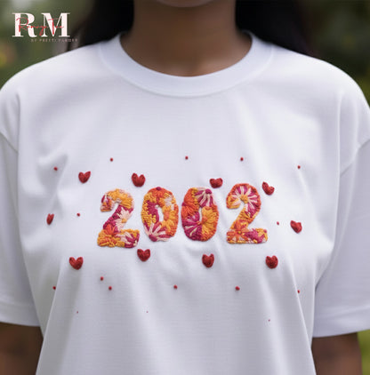 White t-shirt with '2002' design and red hearts, brand 'RM' visible.
